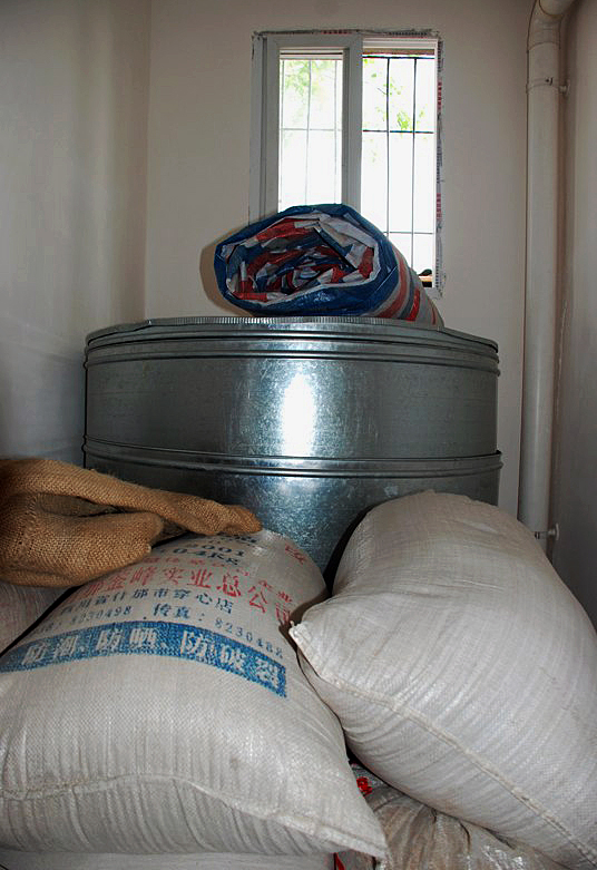 Steel granaries, provided by Amity Foundation, help keep the harvest from spoiling. A UMNS Web-only photo courtesy of Amity Foundation.