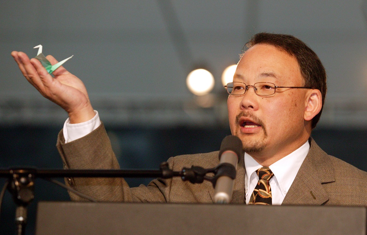 The Rev. Bob Hoshibata holds an origami paper crane, one of about 1,000 that members of the Pacific Northwest delegation to the United Methodist Church's 2004 General Conference folded as prayers for peace. A UMNS photo by Mike DuBose.
