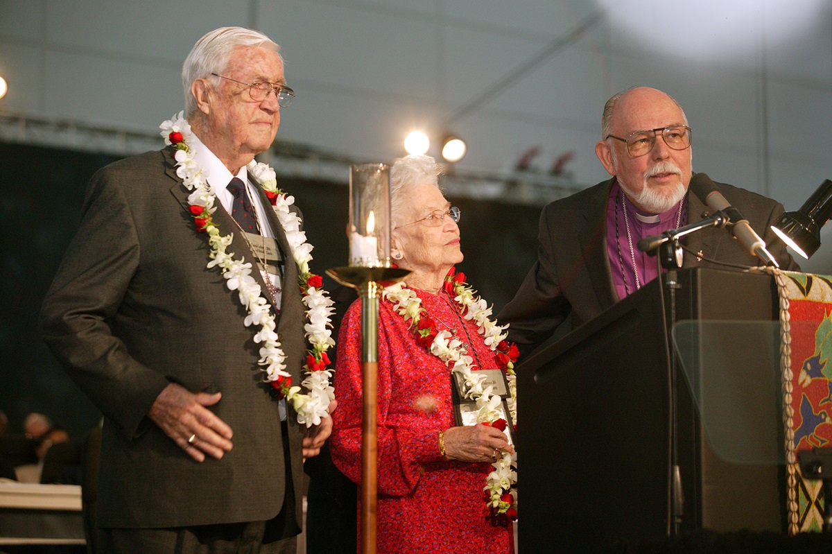 United Methodist Bishop Joel N. Martinez (right), president of the General Board of Global Ministries, honors Eunice Mathews during a session of the denomination's 2004 General Conference in Pittsburgh. The tribute on Mrs. Mathews’ 90th birthday recognized her lifetime of service to the church. Those honoring her include her husband, Bishop James K. Mathews. A UMNS photo by Mike DuBose.