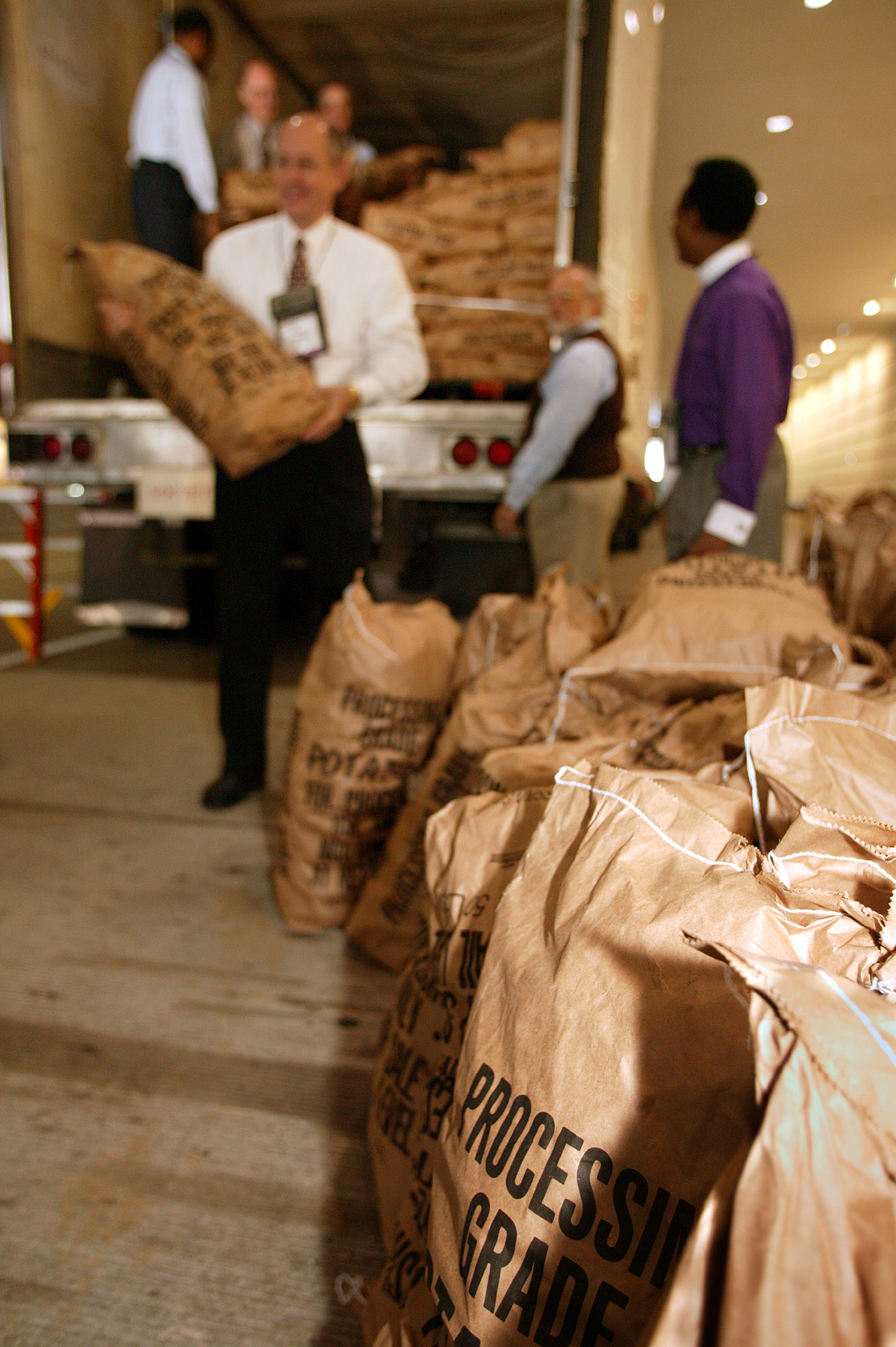 United Methodist bishops and other volunteers help unload 45,000 pounds of potatoes from a truck parked outside the David L. Lawrence Convention Center in Pittsburgh, site of the denomination's 2004 General Conference. The April 29 Potato Drop was sponsored the General Commission on United Methodist Men and the Society of St. Andrew and benefited hunger ministries in the Pittsburgh area. A UMNS photo by Mike DuBose.