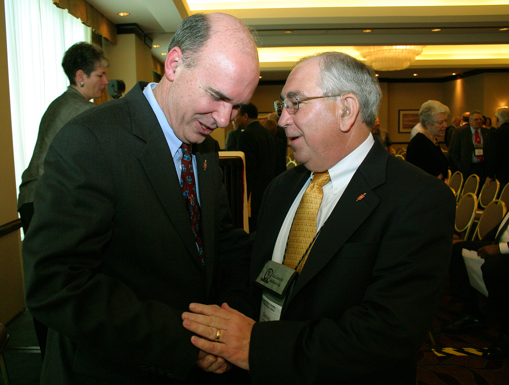 United Methodist Bishop Peter D. Weaver (left), Philadelphia, PA, receives congratulations from Bishop D. Max Whitfield, Albuquerque, NM, following Weaver's installation as president of the denomination's council of bishops during the 2004 General Conference in Pittsburgh. A UMNS photo by Rasul Welch.
