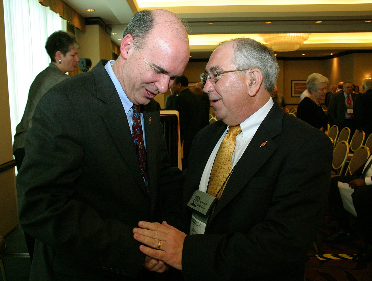 United Methodist Bishop Peter D. Weaver (left), Philadelphia, PA, receives congratulations from Bishop D. Max Whitfield, Albuquerque, NM, following Weaver's installation as president of the denomination's council of bishops during the 2004 General Conference in Pittsburgh. A UMNS photo by Rasul Welch.