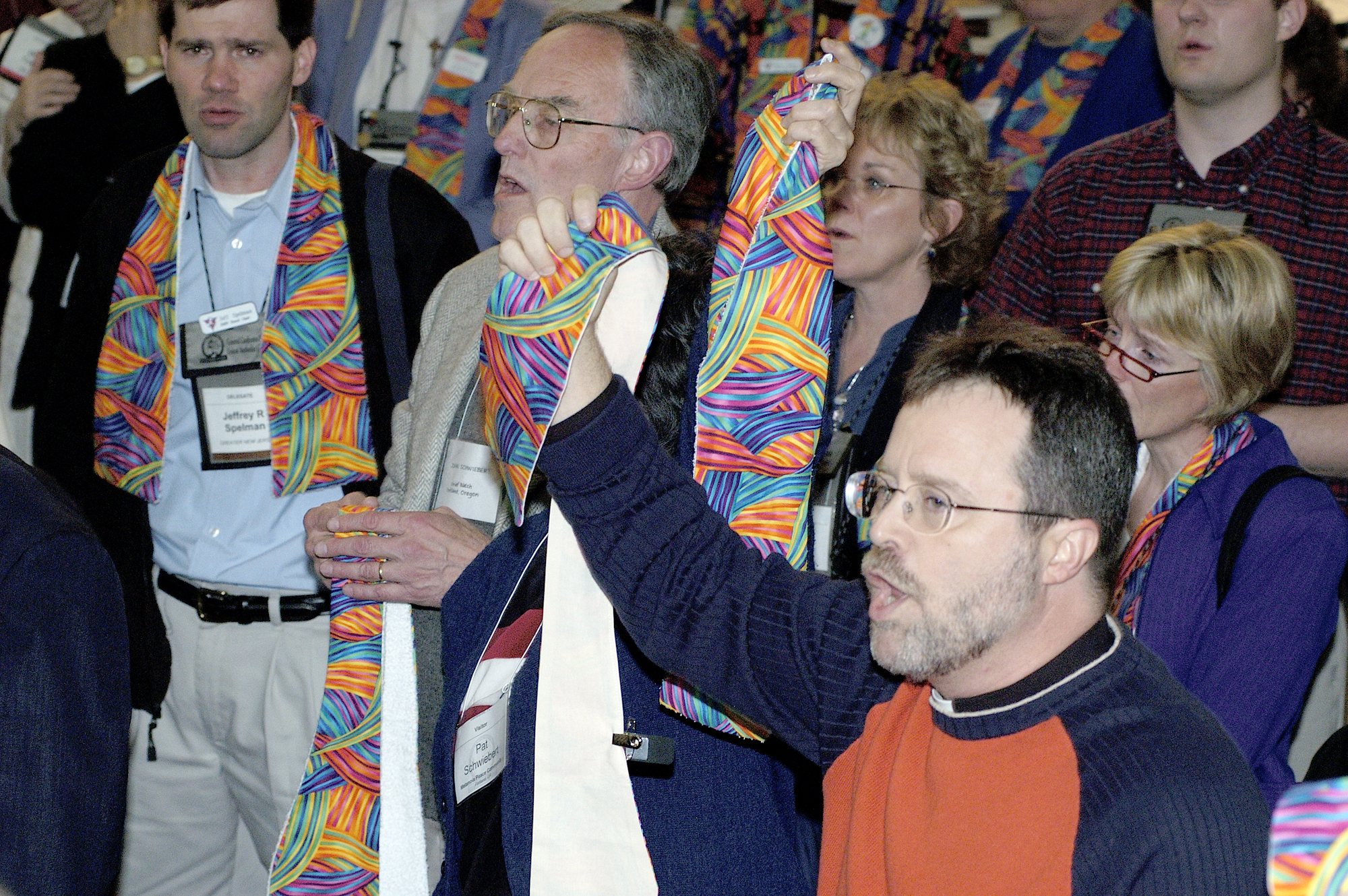 Supporters of wording that would say Christians are not of one mind about the incompatibility of the practice of homosexuality with Christian teaching speak out in protest after delegates to the 2004 United Methodist General Conference in Pittsburgh voted to maintain language in the denomination's Book of Discipline. Many wearing multicolored scarves stood in support of gay men and lesbians throughout the debate and votes. A UMNS photo by Paul Jeffrey