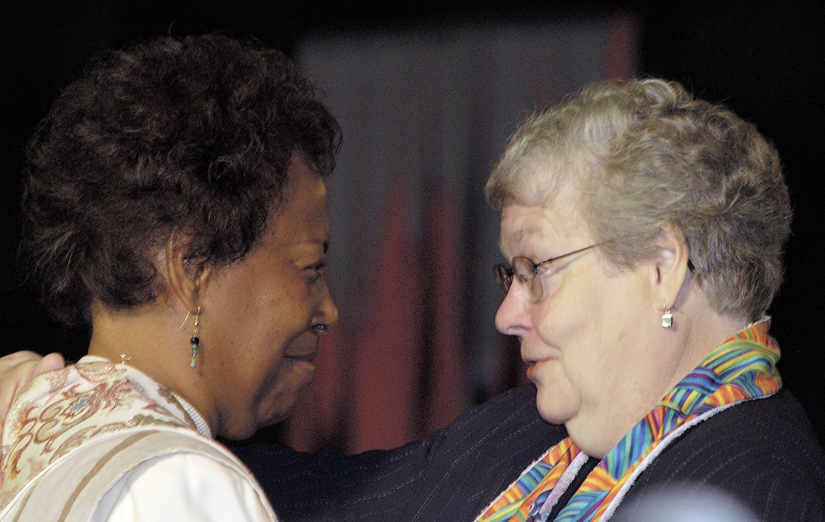 Bishop Beverly J. Shamana, San Francisco Area (left), is greeted by Bishop Judith Craig after Shamana's sermon during morning worship on May 5 during the 2004 United Methodist General Conference in Pittsburgh. A UMNS photo by Paul Jeffrey.