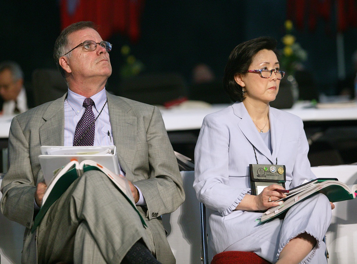 The Rev. Larry Hollon and the Rev. Sung-Ja Lee Moon watch as General Conference approves Igniting Ministry. A UMNS photo by Mike DuBose.