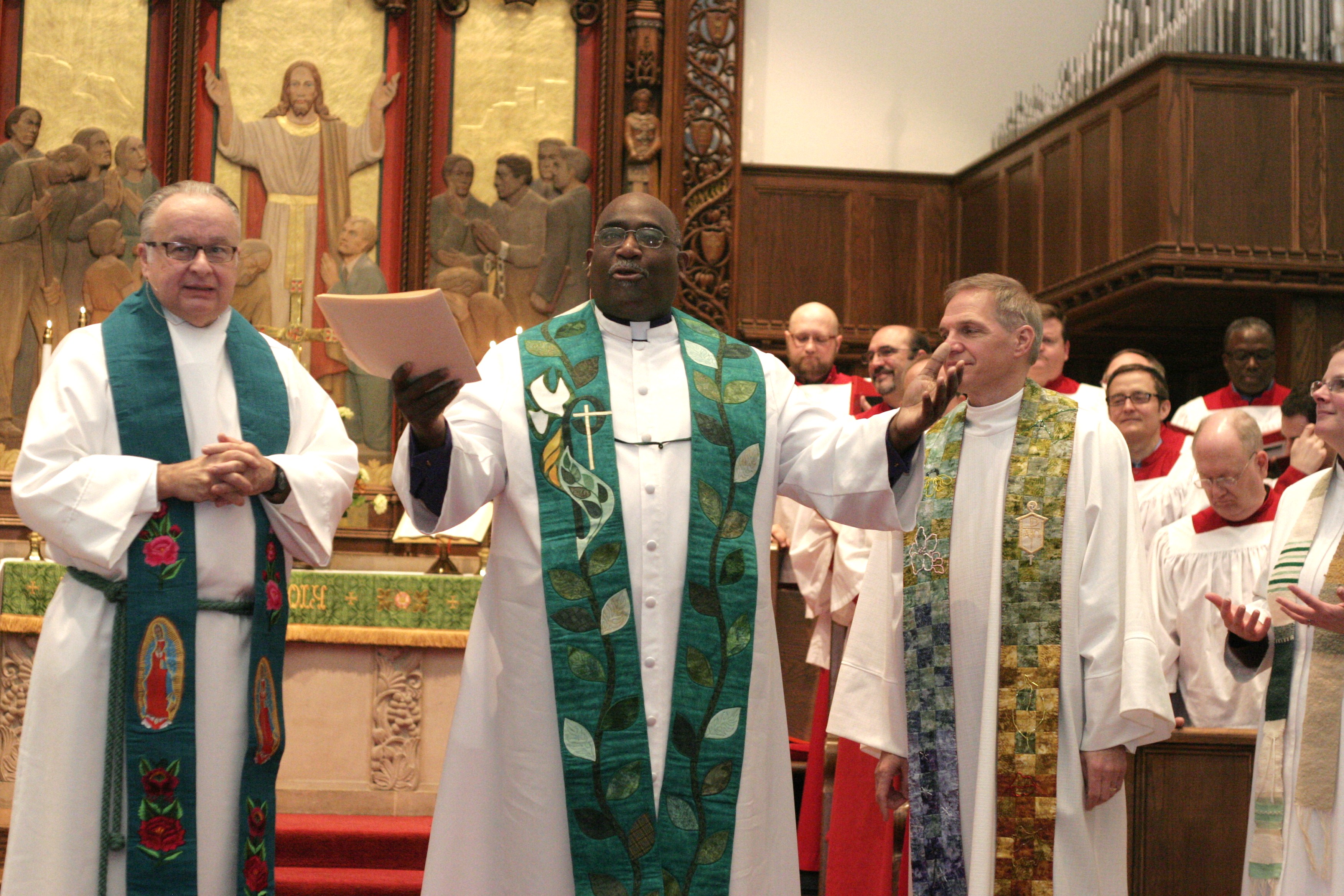 Rev. Dean Snyder, Bishop Gregory Palmer and Bishop John Schol stand together at the end of worship service at Foundry United Methodist Church on Jan. 18.
