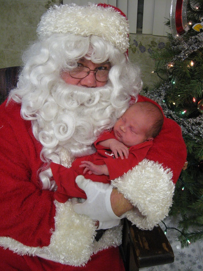 Santa cradles a newborn at Santa Claus United Methodist Church in Santa Claus, Ind. 
Photo courtesy of Julie Schnell