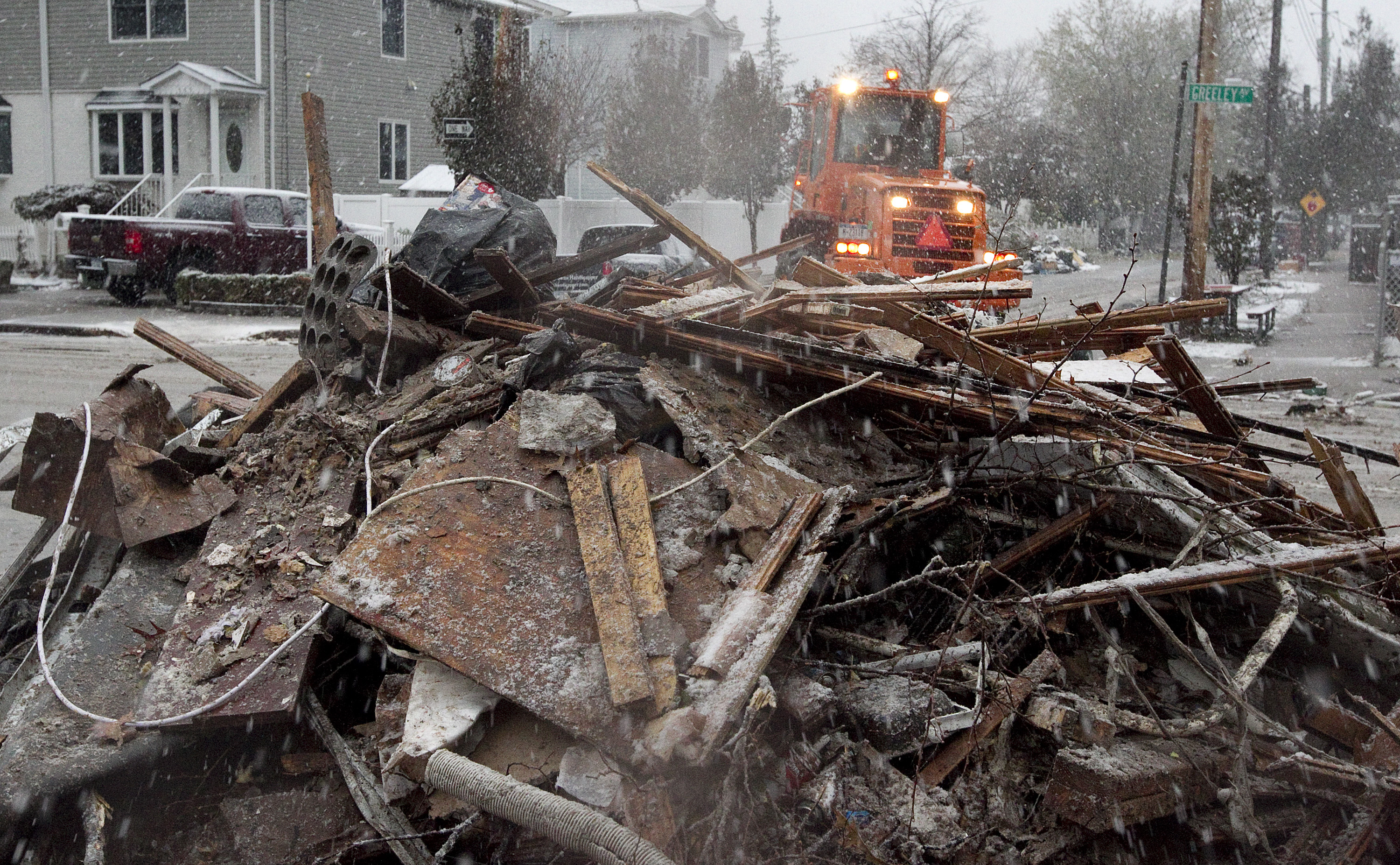 Workers pile up debris from Hurricane Sandy in the midst of a nor’easter snowstorm in the Staten Island borough of New York. A UMNS photo by Mike DuBose.