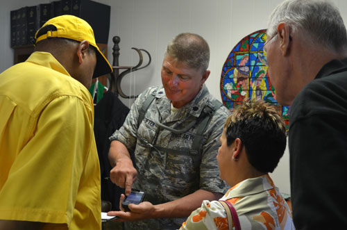 The Rev. Tim Neustifter, a chaplain and lieutenant colonel in the Louisiana Air National Guard, shows the conference assessment team photos he took of flooded areas near Belle Chasse, La.