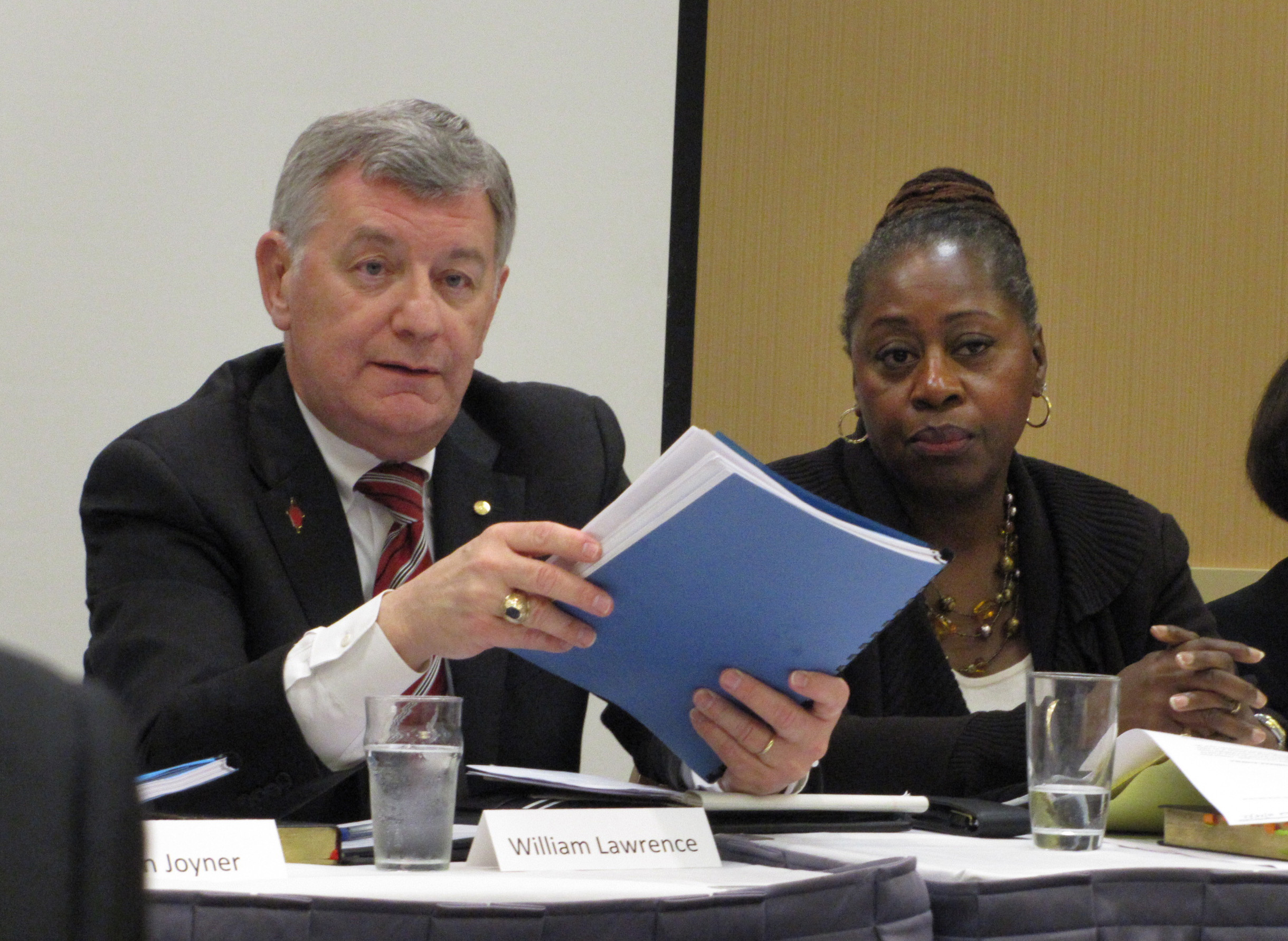 Court members William B. Lawrence and Angela Brown listen to Bishop Daniel Wandabula’s testimony.