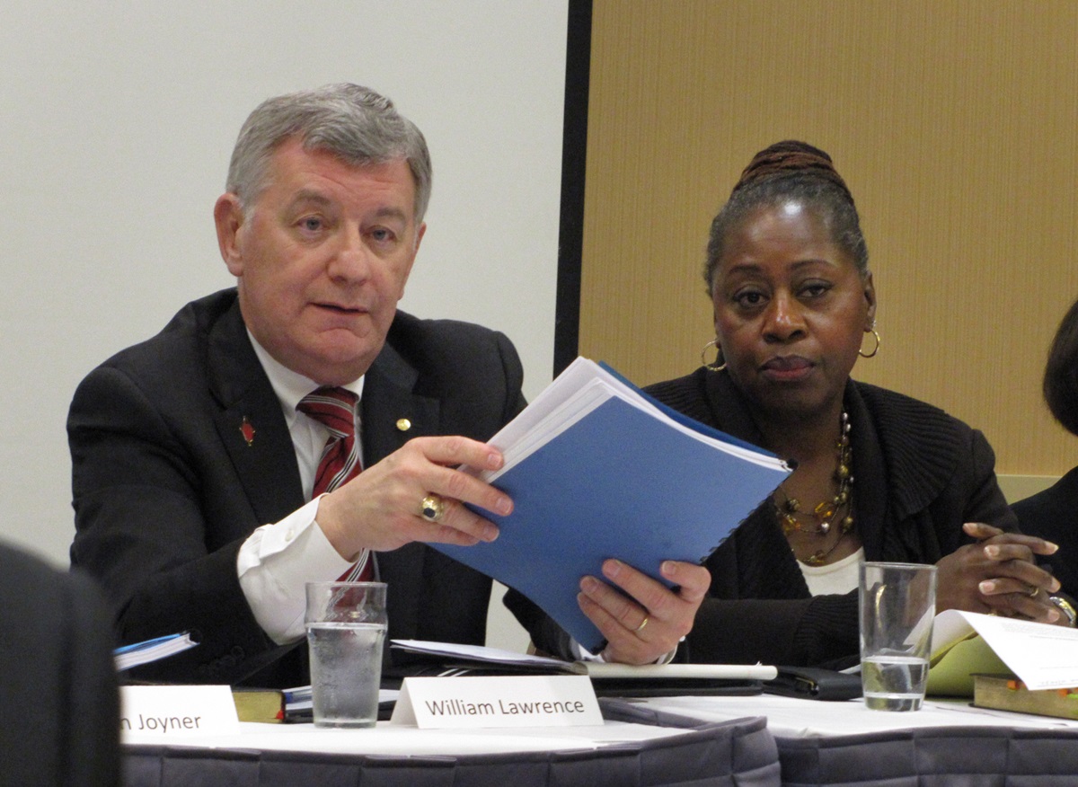 Court members William B. Lawrence and Angela Brown listen to Bishop Daniel Wandabula’s testimony.
