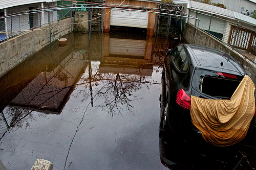 A house in New Jersey, already swamped in oily muck, is also being inundated with chemicals from the flooded factory behind it.
PHOTO CREDIT: Chris Heckert
