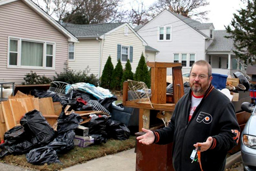 The Rev. Don Stevens sorts through his ruined belongings. Photo by Sushil Bhujbal.