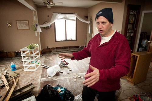 Peter Vasquenz describes damage to his mother’s home in the Staten Island borough of New York following Hurricane Sandy. Vasquenz, a firefighter in Brooklyn, had been ripping out waterlogged drywall and flooring. A UMNS photo by Mike DuBose