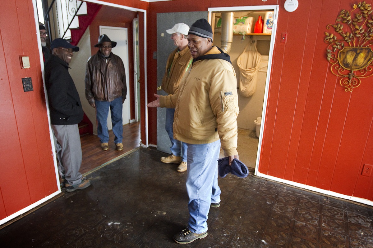 Leroy Morgan (right) provokes smiles among United Methodist Church officials and relief workers as he describes using a garden hose to remove jellyfish that were washed into his Freeport, N.Y., home by Hurricane Sandy. UMNS photos by Mike DuBose.