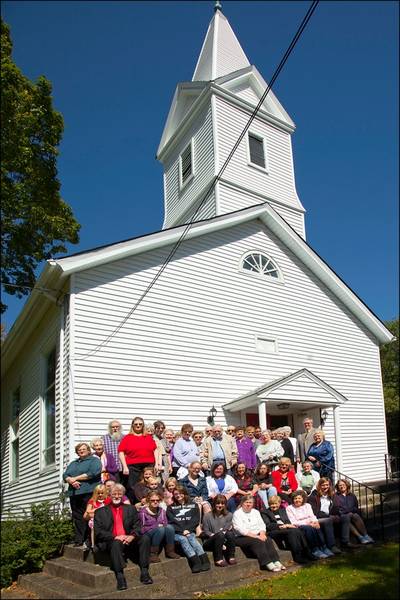 Members stands before Drakestown (N.J.) United Methodist Church for its 200th anniversary. The church and its new electric sign provided a beacon for storm-tossed New Jersey residents. Photo courtesy of Drakestown United Methodist Church.