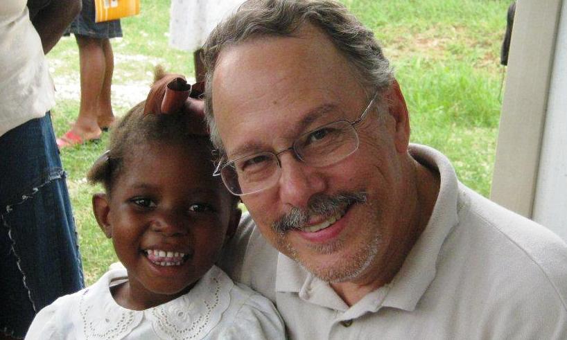 Gil Hanke and one of the 415 Haitian children tested for hearing loss, and suitability for hearing aids. Photo by Dr. Ricardo Gautier