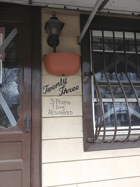 The note on the door from rescue workers tells the story of what New Dorp endured: 3 people, 1 dog, all survived.