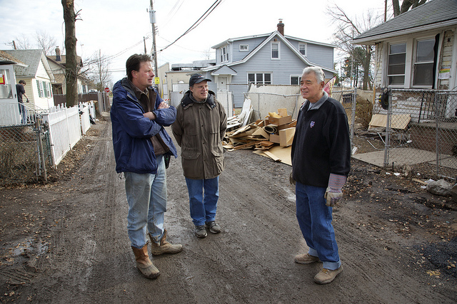Scott Mikkelson(left) and the Rev. Matt Schaeffer (center), who coordinate the church’s Sandy relief work on Staten Island, talk with John Stonick, whose home was one of many damaged by the storm. Photos by Arthur McClanahan, Iowa United Methodist Conference.