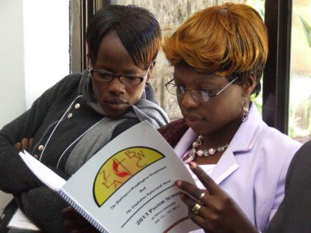 The Revs. Josephine Bangure and Tivai Mudzengerere go through the Pastors’ School booklet.UMNS web-only photo by Taurai Emmanuel Maforo.