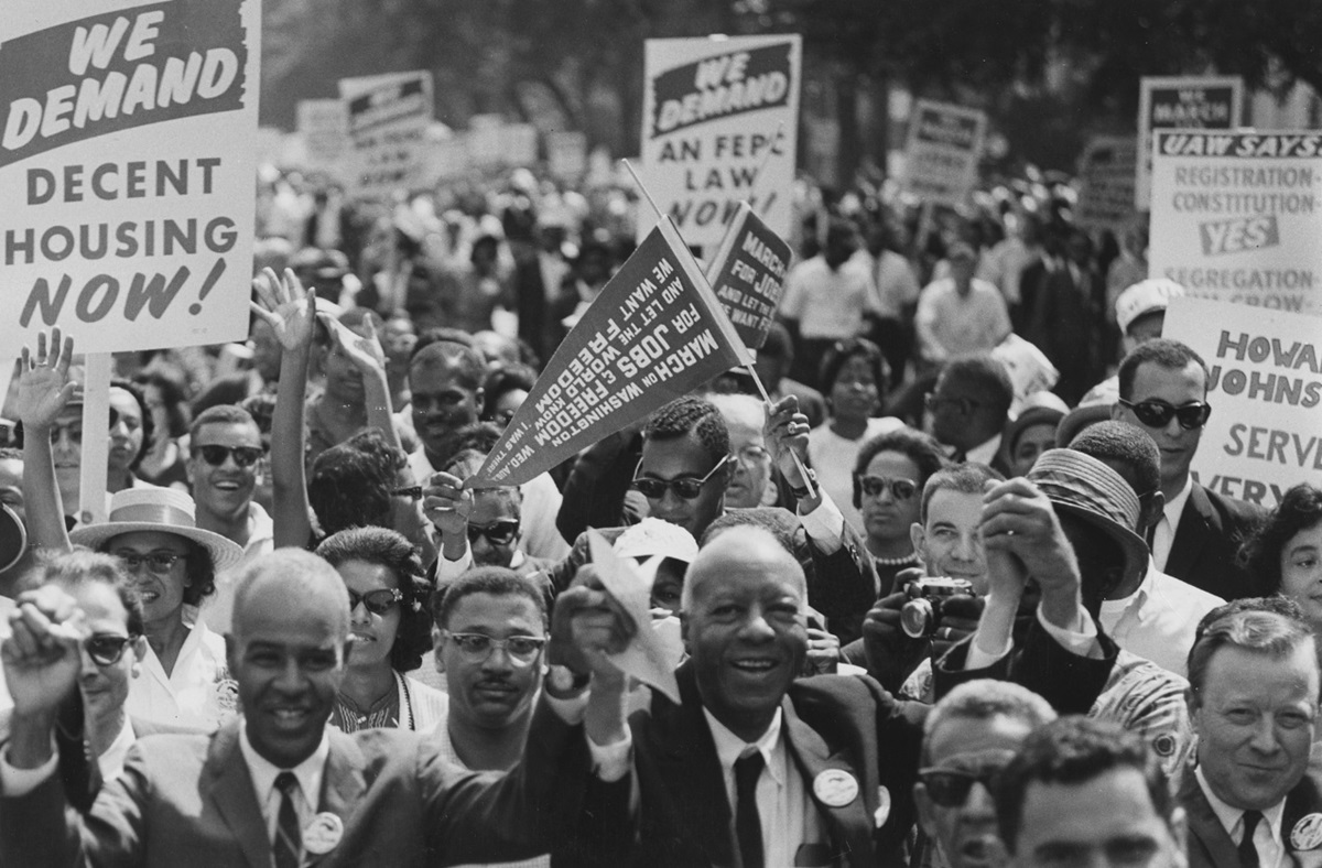 Labor organizers help lead marchers from the Washington Monument to the Lincoln Memorial on Aug.28, 1963, during the March on Washington for Jobs and Freedom. Holding hands near the front are Roy Wilkins (left), executive secretary of the National Association for the Advancement of Colored People; A. Philip Randolph (center), organizer of the demonstration; and Walter P. Reuther, president of the United Automobile Workers Union and Vice President of the American Federation of Labor and Congress of Industrial Organizations. Photo courtesy of Wikimedia Commons.