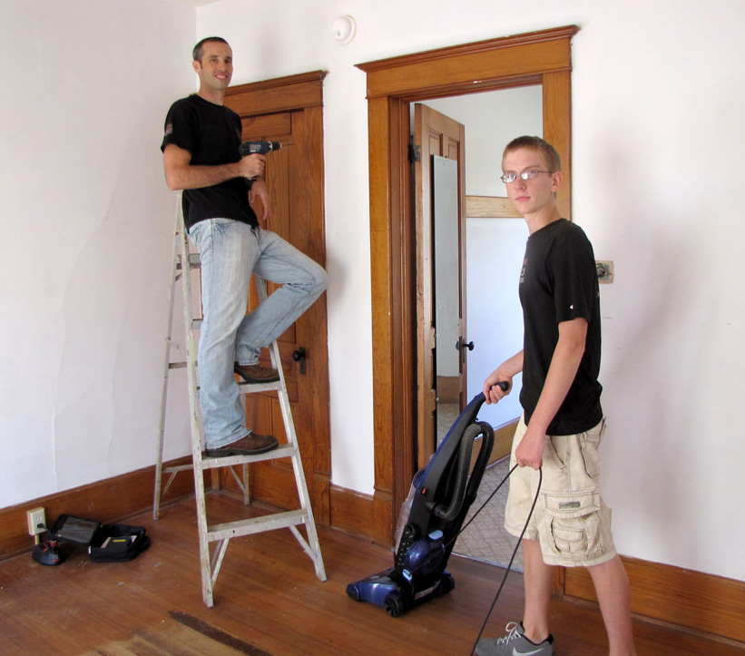 Volunteers Bryce Riemer and Joe Jackson clean and repair the day center for Family Promise of Green County. Photo by Deb Weis.