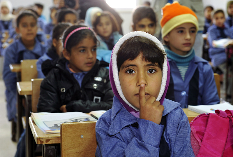 Children inside a classroom at Za’atri refugee camp, host to tens of thousands of Syrians displaced by conflict, near Mafraq, Jordan. U.N. Secretary-General Ban Ki-moon visited the camp as part of a two-leg trip to Jordan and Turkey to assess the Syrian refugee situation in those countries. Photo ID 537316. 07/12/2012. Mafraq, Jordan. U.N. Photo/Mark Garten.