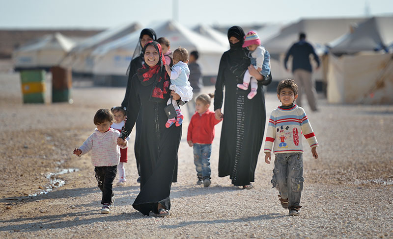 Women and children walk through the Zaatari Refugee Camp near Mafraq, Jordan. Opened in July, 2012, the camp holds more than 50,000 refugees from the civil war inside Syria. The United Methodist Committee on Relief has worked with its partners to assist the refugees. Other United Methodists are urging negotiations instead of a U.S. military attack on Syria. Photo © Paul Jeffrey, ACT Alliance.