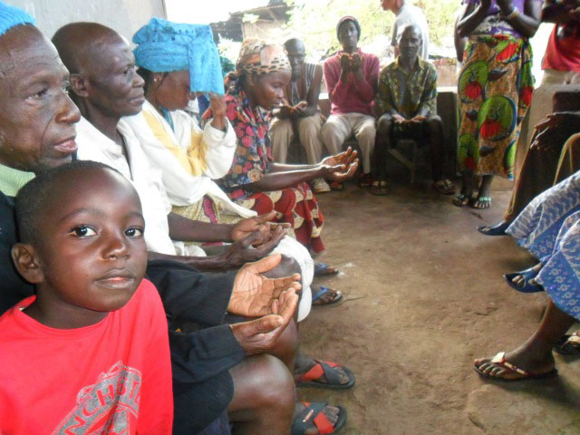 Community members pray for the new school under construction in Lungi, Sierra Leone. Photos by Phileas Jusu, Sierra Leone Annual Conference.