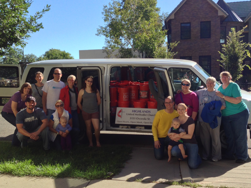Members of Highlands United Methodist Church in Denver pose with cleaning buckets they prepared for those affected by the Colorado floods. A UMNS photo by the Rev. Bradley Laurvick.