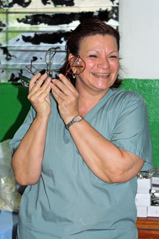 Jean Arnwine displays several pairs of glasses during a light moment at the Haiti Eye Clinic in Petit-Goâve, Haiti. 