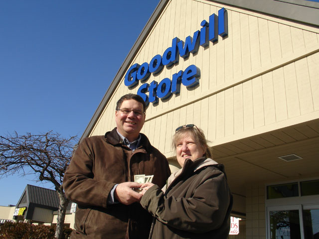 Ed Metzler and his wife, Erma distributed $50 worth of $1 and $5 bills Dec. 21 at a Goodwill Store as part of a Christmas outreach. Photo by Dan Gangler, Indiana Annual Conference