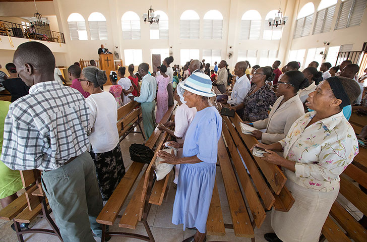 Noelzina Doavil (right) joins fellow parishioners in singing a hymn during worship at St. Martin Methodist Church. Doavil, who was at choir practice when the earthquake hit, and another choir member were trapped in the rubble when the church collapsed.