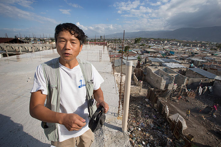 Seung Don Kim stands atop the mission center in Cité Soleil.