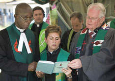 Clergy from the United Methodist Côte d'Ivoire and Texas annual conferences recite a prayer during a dedication service for mosquito net distribution at the Methodist Hospital of Dabou.