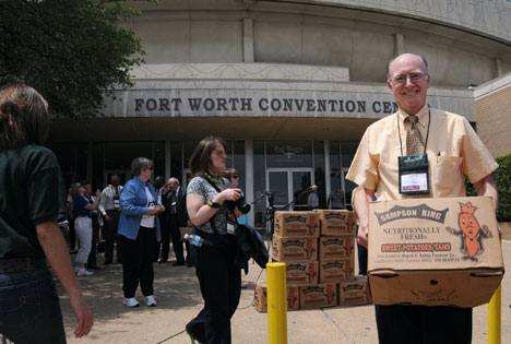 United Methodist Bishop Kenneth Carder helps load donated sweet potatoes for distribution to area missions serving the hungry in Fort Worth, Texas. 