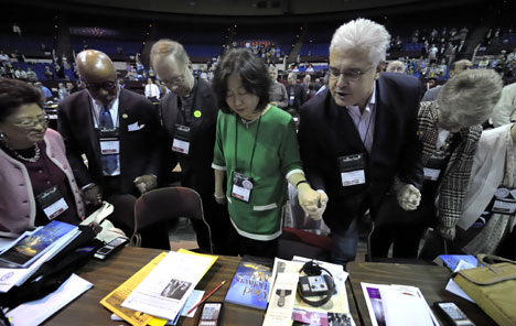 Members of the New York Annual (regional) Conference pray together before the beginning of the April 27 session of the 2008 United Methodist General Conference. 