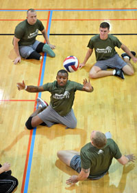 Wounded, ill and injured current and former members of the military compete in a sitting volleyball tournament in the Pentagon gym.