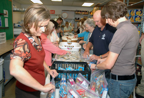 Holley Williams (left) and Ronnie Crowley pack after-school snacks for needy children as part of the Snack Sacks ministry of Arborlawn United Methodist Church in Fort Worth, Texas. UMNS photos by John Gordon.