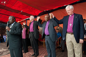 United Methodist Bishop Nkulu Ntambo (front) leads the closing prayer after an assembly in observance of the 2010 World Malaria Day in Kamina, Democratic Republic of the Congo. A UMNS photo by Lynne Dobson.