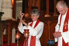 Bishop Peggy Johnson blesses the communion elements during her consecration service at the Northeastern Jurisdictional Conference. A UMNS photo by Suzy Keenan.