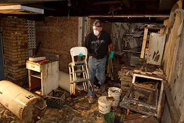 Volunteer Tim Guth helps clean up flood damage at the home of Edward Ortiz in Minot, N.D., in August 2011. He is part of a Volunteers in Mission Team from the Indiana Annual (regional) Conference of The United Methodist Church. A UMNS file photo by Mike DuBose.