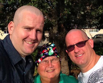 (From left) Clark and Tom Christmas shave their heads in support of Jo Christmas (center) during her chemotherapy.