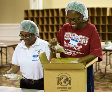 Volunteers pack boxes during the Stop Hunger Now event.