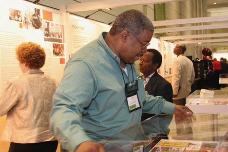 John Coleman of the United Methodist Commission of Religion and Race makes last- minute adjustments to the agency's Journey to Inclusiveness exhibit at the 2008 General Conference in Fort Worth, Texas.