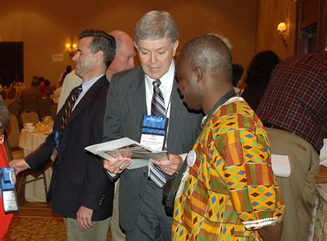 The Rev. James Heidinger, president and publisher of Good News, speaks with the Rev. Jerry Kulah, a Liberian delegate, during an April 25 Renewal and Reform Coalition breakfast briefing at the Fort Worth Hilton Hotel.