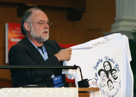 The Rev. David Farley, pastor of Echo Park United Methodist Church in Los Angeles, holds T-shirt bearing the likeness of immigrants in sanctuary around the country at an April 25 press conference hosted by the United Methodist Task Force on Immigration. 