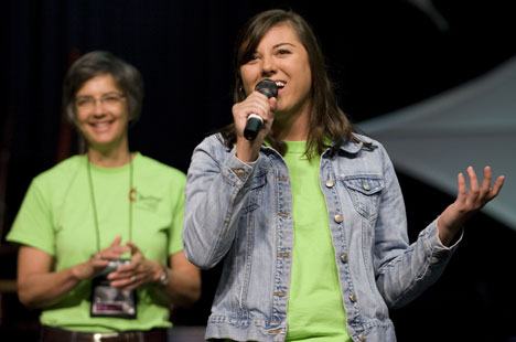 Elizabeth Cumbest sings a song she wrote to help raise money for the reconstruction of Seashore United Methodist Assembly, a Mississippi church that was destroyed by Hurricane Katrina. With Bishop Hope Morgan Ward in the background, Cumbest sang during the 2008 United Methodist General Conference. Photo by Mike DuBose, UMNS.
