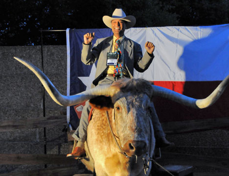 Solomon Christian gets his photo made atop a long-horned steer at "The Stars at Night, a Taste of Texas" reception April 27 at the Fort Worth Convention Center, site of the 2008 United Methodist General Conference. 
