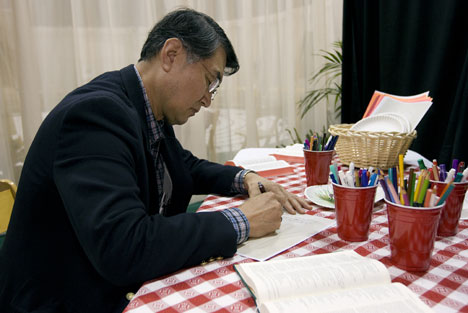 The Rev. Bo Joong Kim finds a quiet space to write in the Prayer Room at the 2008 United Methodist General Conference in Fort Worth, Texas.